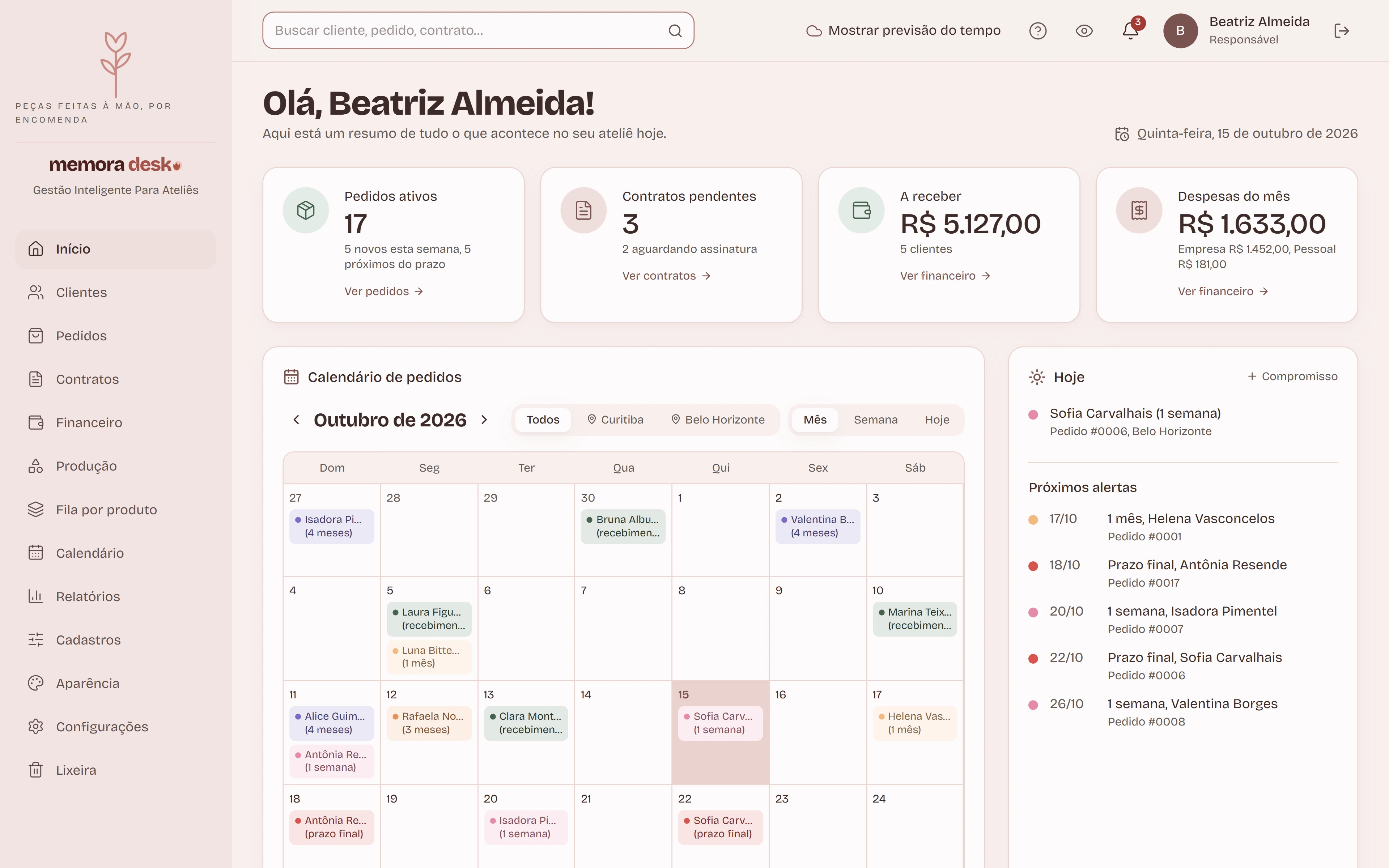 Tela inicial do sistema com a identidade do ateliê de exemplo Flor de Maio: o menu mostra a logomarca e a descrição do ateliê, e as cores dos cartões, botões e calendário seguem as duas cores escolhidas.